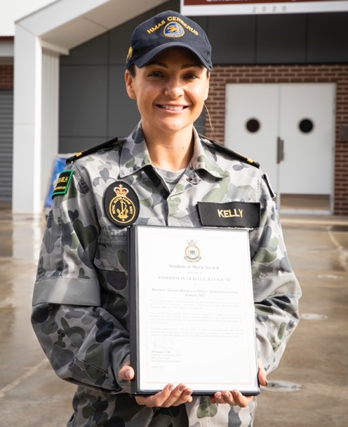 A person in a uniform holding a certificate

Description automatically generated with low confidence
